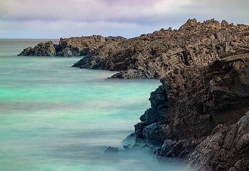 Lava rocks along tranquil shoreline of San Cristobal Island-Galapagos-Ecuador Coastal Print